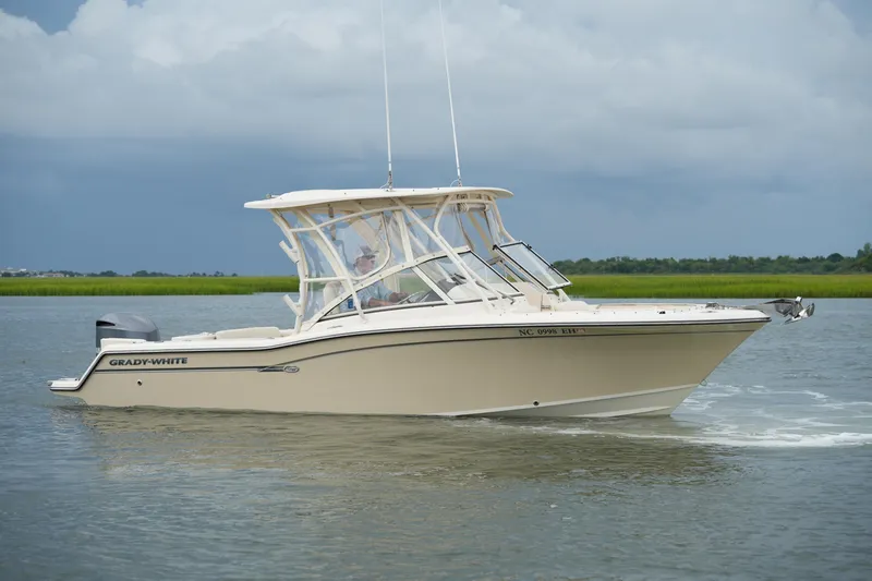 Slide: The Image of 2018 Grady-White Freedom 235 boat cruising on a calm waterway. - 7