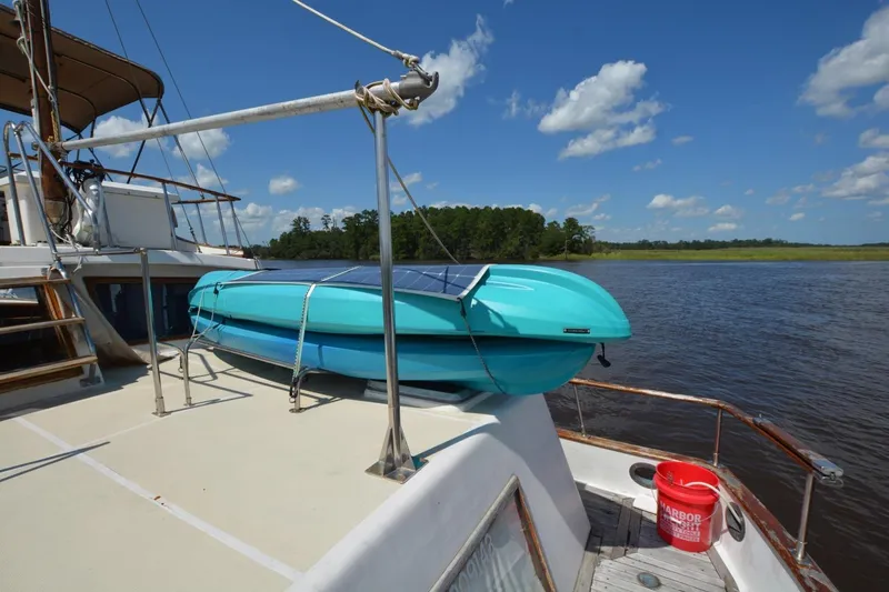 Slide: The Image of 1985 Albin 43 Trawler kitchen with stove, microwave, sink, and wooden cabinetry. - 12