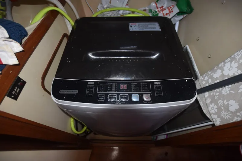 Slide: The Image of Cozy bedroom in 1985 Albin 43 Trawler with nautical decor and striped bedding. - 14