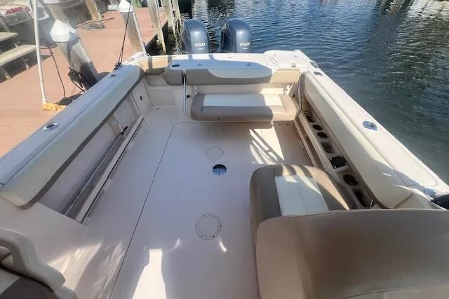 Slide: The Image of 2013 Grady-White Freedom 275 boat interior with seating and twin engines. - 10