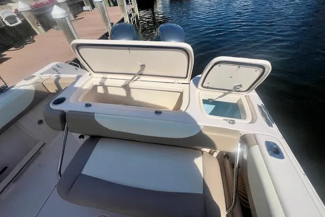 Slide: The Image of 2013 Grady-White Freedom 275 boat with open storage compartments by the water. - 11