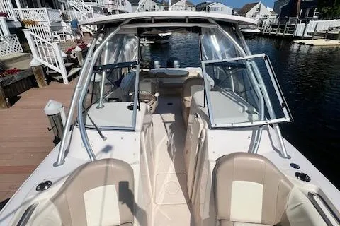 Slide: The Image of 2013 Grady-White Freedom 275 boat docked by waterfront homes. - 12