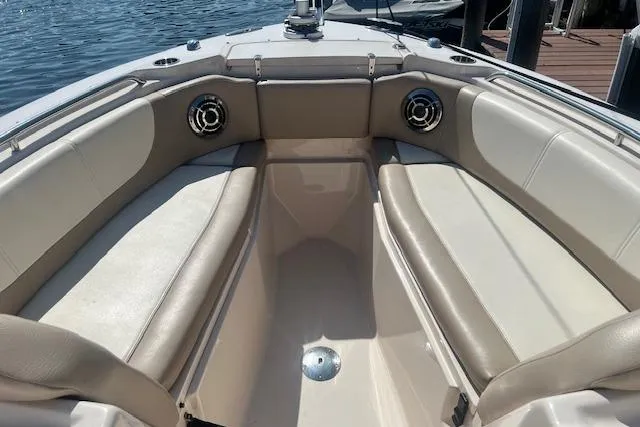 Slide: The Image of 2013 Grady-White Freedom 275 boat interior with cushioned seating and speakers. - 13