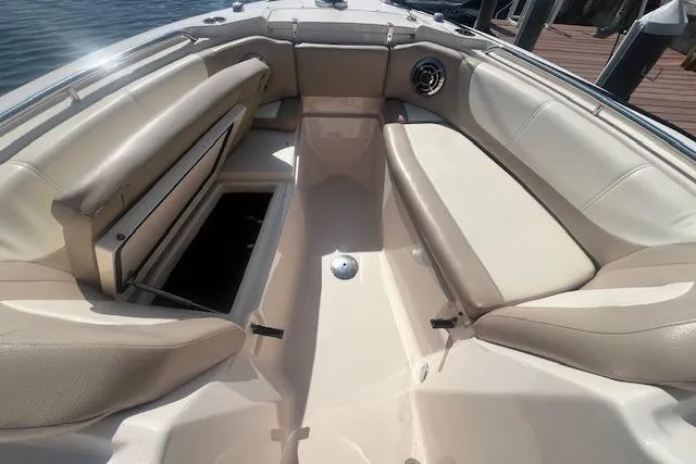 Slide: The Image of 2013 Grady-White Freedom 275 boat interior with beige seating and storage compartments. - 15