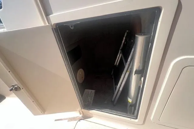 Slide: The Image of Open storage compartment on a 2013 Grady-White Freedom 275 boat, showing interior space. - 16