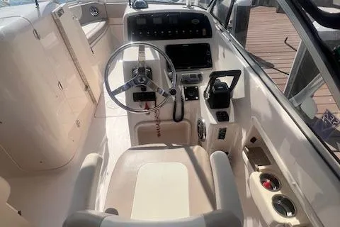 Slide: The Image of 2013 Grady-White Freedom 275 boat cockpit with steering wheel and control panel. - 4