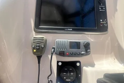 Slide: The Image of 2013 Grady-White Freedom 275 boat dashboard with navigation and communication equipment. - 7