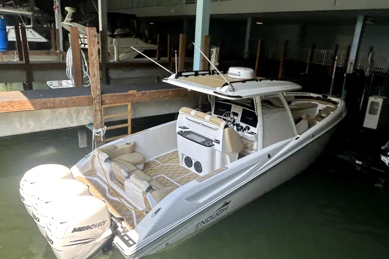 Slide: The Image of 2019 Sunsation 34 CCX boat in a garage, featuring Mercury outboard engines. - 1