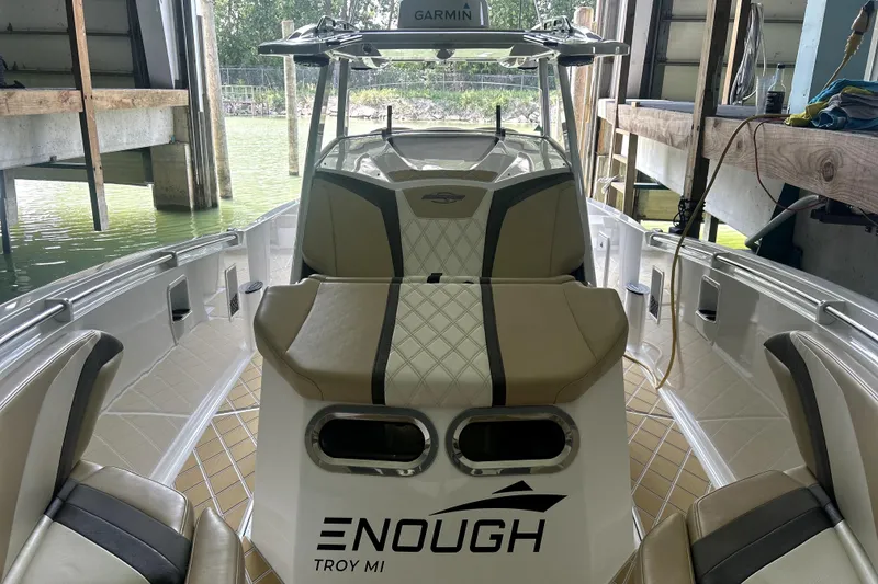 Slide: The Image of 2019 Sunsation 34 CCX boat interior with beige and black cushioned seating. - 13