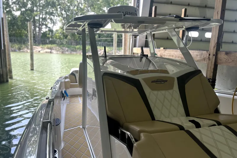 Slide: The Image of 2019 Sunsation 34 CCX cabin interior with beige and white cushioned seating. - 15