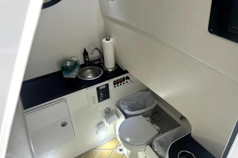 Slide: The Image of 2019 Sunsation 34 CCX boat interior with tan seating and Garmin equipment. - 17