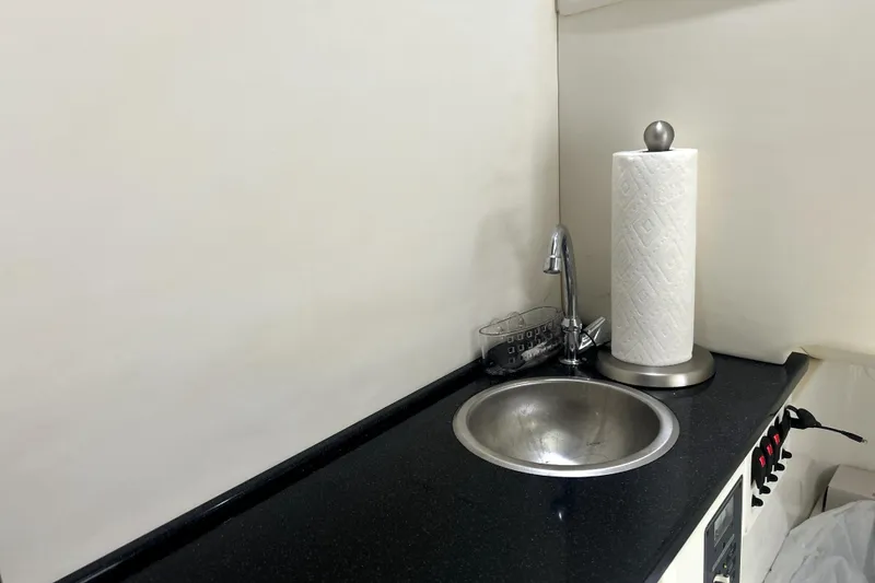 Slide: The Image of 2019 Sunsation 34 CCX boat docked in a marina, featuring luxurious seating. - 19