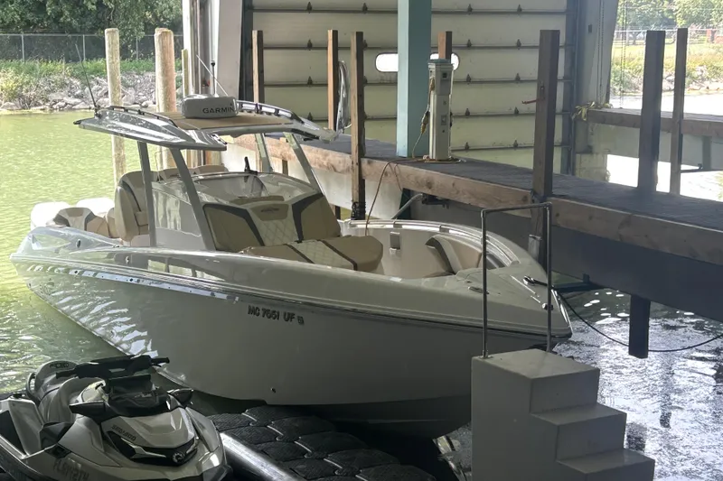 Slide: The Image of 2019 Sunsation 34 CCX boat hull with visible thruster detail. - 2