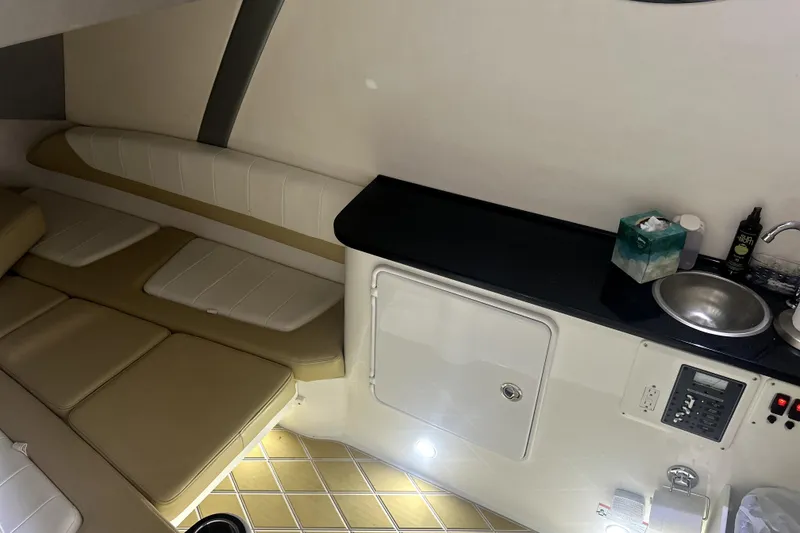 Slide: The Image of 2019 Sunsation 34 CCX cabin interior with beige and white cushioned seating. - 20