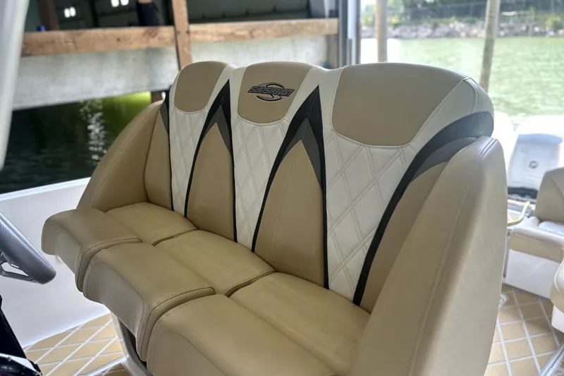 Slide: The Image of Reflection in oval mirror with "Sunsation" logo on 2019 Sunsation 34 CCX boat interior. - 28