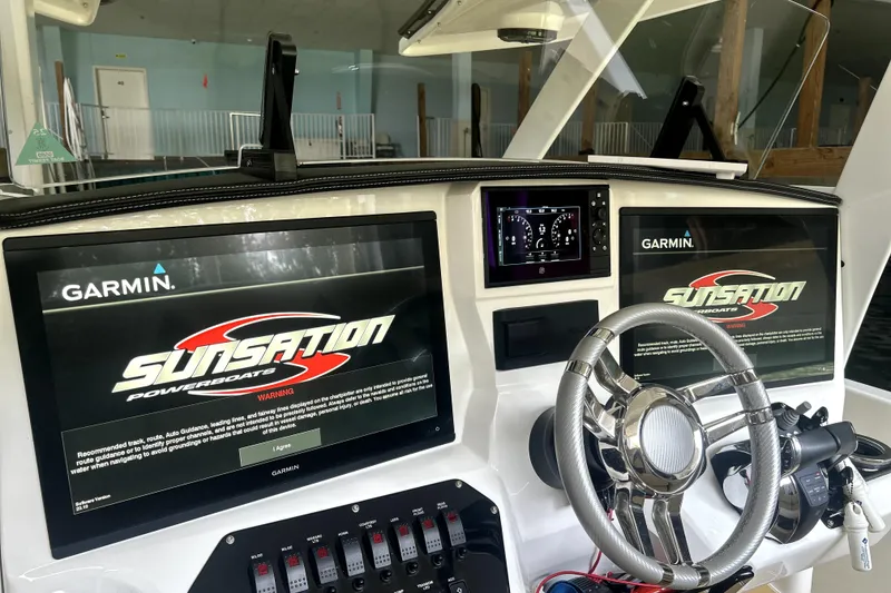 Slide: The Image of 2019 Sunsation 34 CCX boat interior with beige and white cushioned seating. - 33