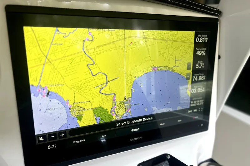 Slide: The Image of 2019 Sunsation 34 CCX boat dashboard with Garmin displays and Mercury controls. - 34