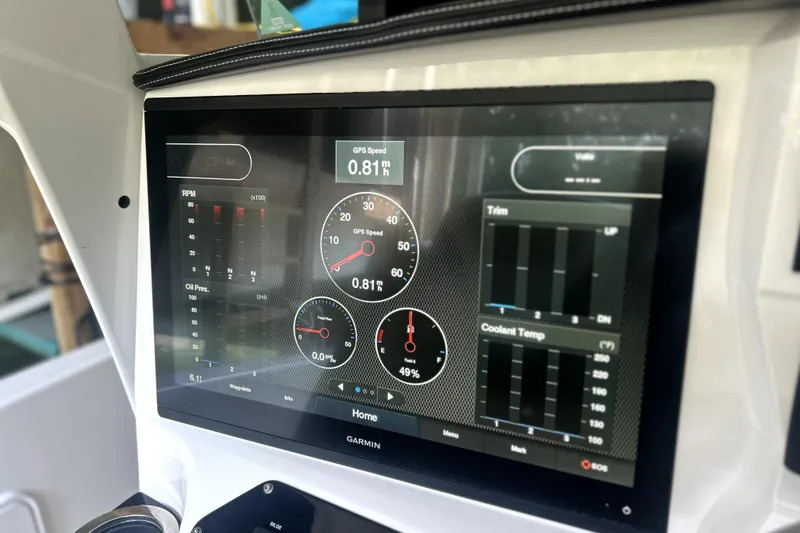 Slide: The Image of 2019 Sunsation 34 CCX boat dashboard with Garmin displays and Mercury controls. - 35