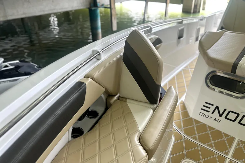 Slide: The Image of 2019 Sunsation 34 CCX boat docked, featuring triple Mercury engines and modern cockpit design. - 5