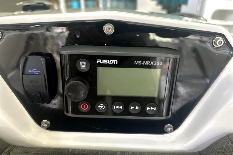 Slide: The Image of 2019 Sunsation 34 CCX boat interior with beige diamond-stitched seating and modern dashboard. - 7