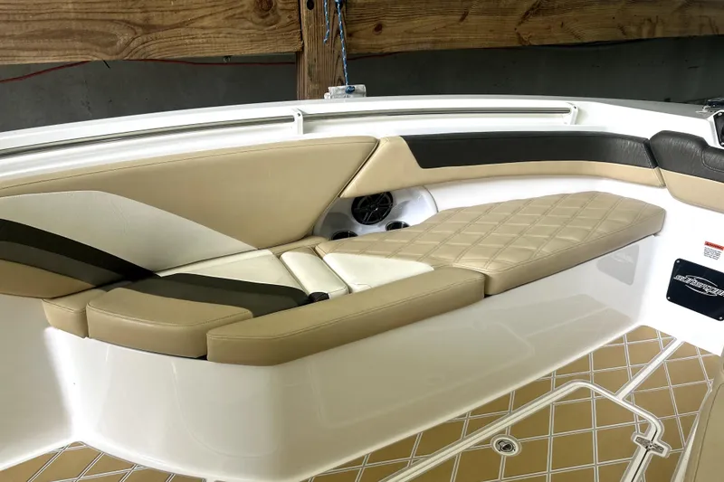 Slide: The Image of 2019 Sunsation 34 CCX boat interior with beige diamond-stitched seating and cup holders. - 9