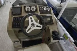 Slide: The Image of 2025 SunChaser Vista 22 Fish boat dashboard with steering wheel and control panel. - 9