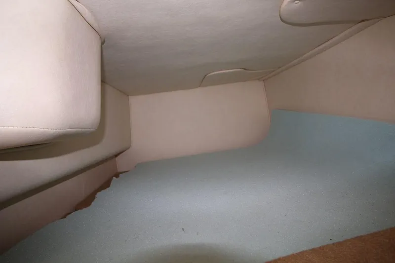 Slide: The Image of Interior cabin view of a 2005 Sea Ray 280 Sundancer boat, featuring beige upholstery. - 16