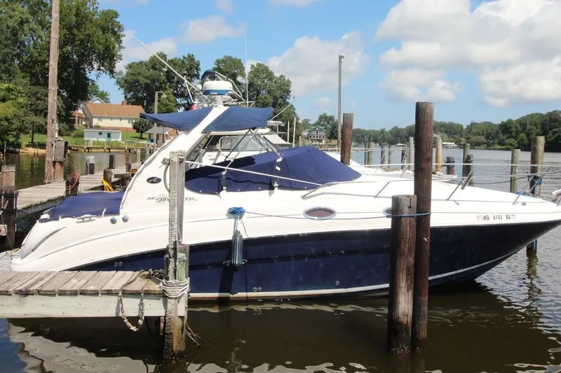 Slide: The Image of 2005 Sea Ray 280 Sundancer docked at a marina on a sunny day. - 2