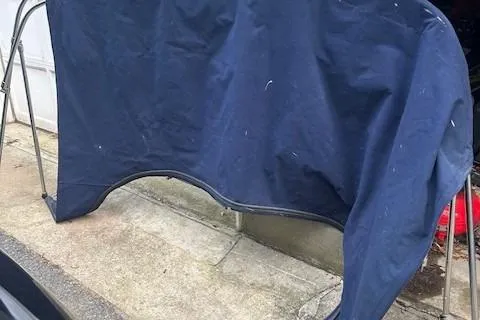 Slide: The Image of Blue canvas cover for 2005 Sea Ray 280 Sundancer boat, displayed on a metal frame. - 20