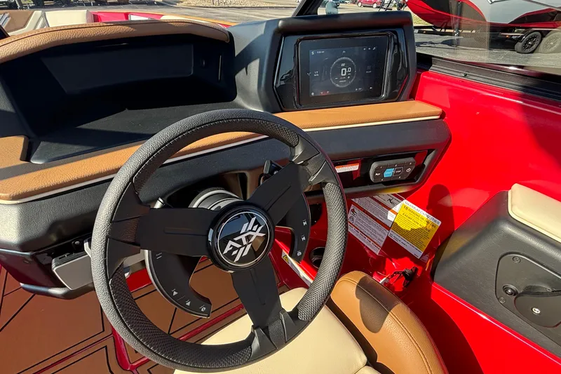 Slide: The Image of 2026 ATX Surf Boats 24 Type-S dashboard with steering wheel and touchscreen display. - 16