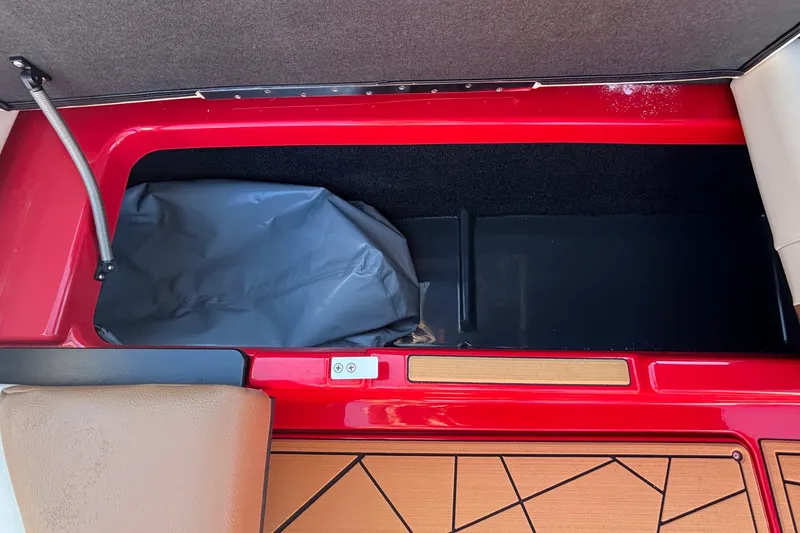 Slide: The Image of Storage compartment in 2026 ATX Surf Boats 24 Type-S, featuring red and tan interior. - 18