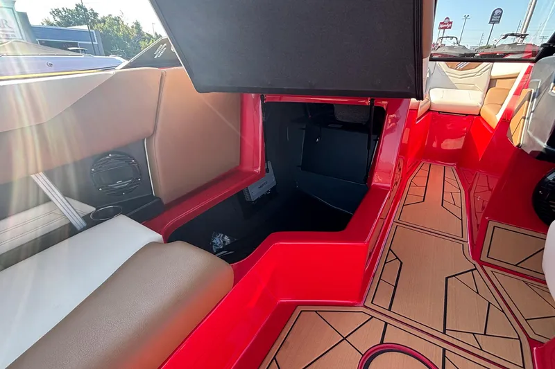 Slide: The Image of 2026 ATX Surf Boats 24 Type-S interior with red accents and storage compartment. - 20