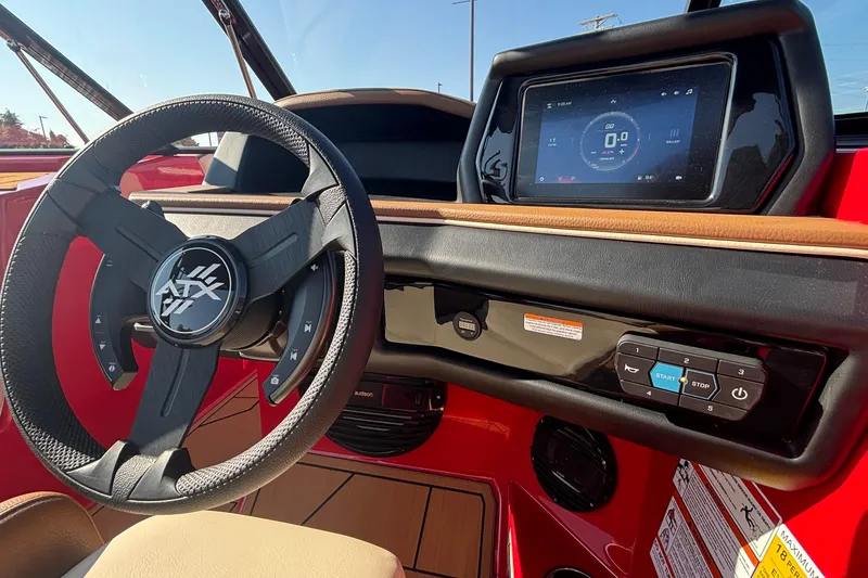Slide: The Image of 2026 ATX Surf Boats 24 Type-S dashboard with steering wheel and touchscreen display. - 23