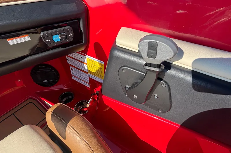 Slide: The Image of Interior controls of 2026 ATX Surf Boats 24 Type-S, featuring red and beige accents. - 24