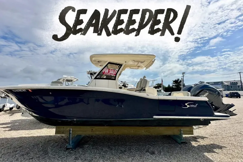 The Image of 2024 Scout 277 LXF boat with "Seakeeper" text, displayed outdoors for sale. - 0