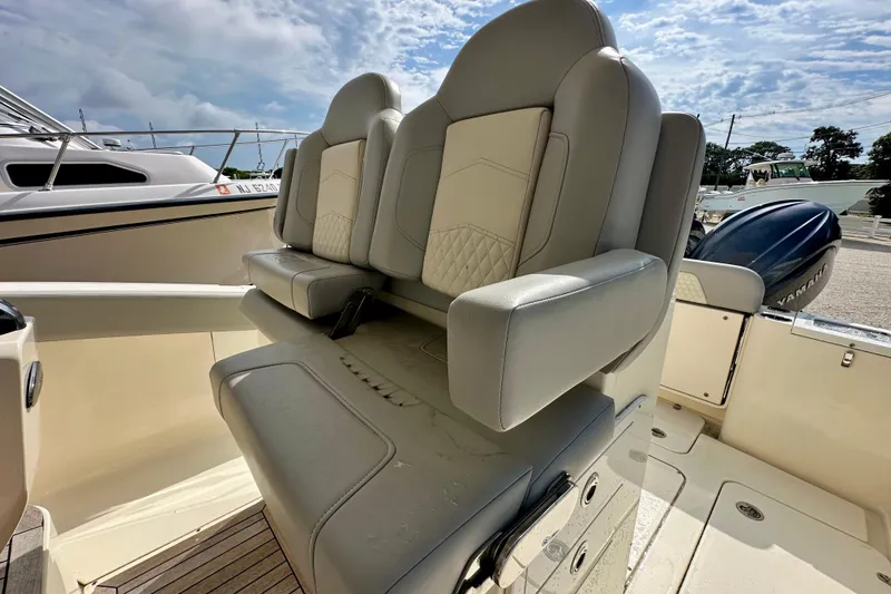 Slide: The Image of 2024 Scout 277 LXF boat interior with luxurious seating and Yamaha engine. - 11