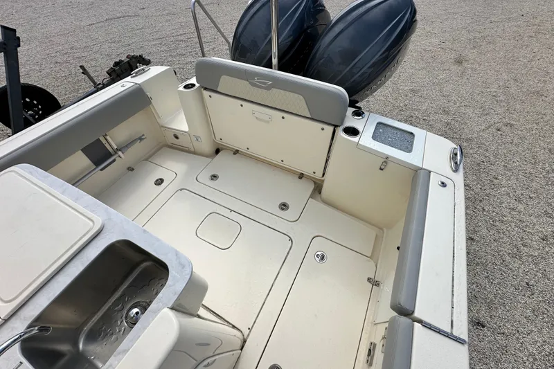 Slide: The Image of 2024 Scout 277 LXF boat interior with seating, storage, and sink. - 16