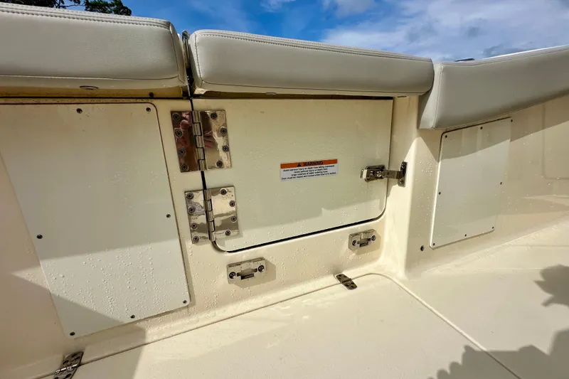 Slide: The Image of 2024 Scout 277 LXF boat interior with cushioned seating and storage compartments. - 17