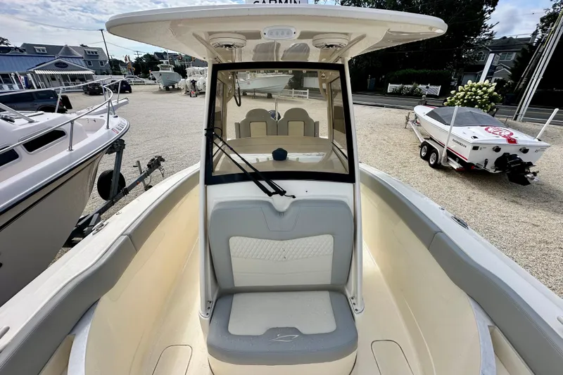 Slide: The Image of 2024 Scout 277 LXF boat interior with seating and windshield, displayed outdoors. - 20
