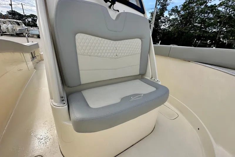 Slide: The Image of 2024 Scout 277 LXF boat seat with gray and white cushioned design. - 21