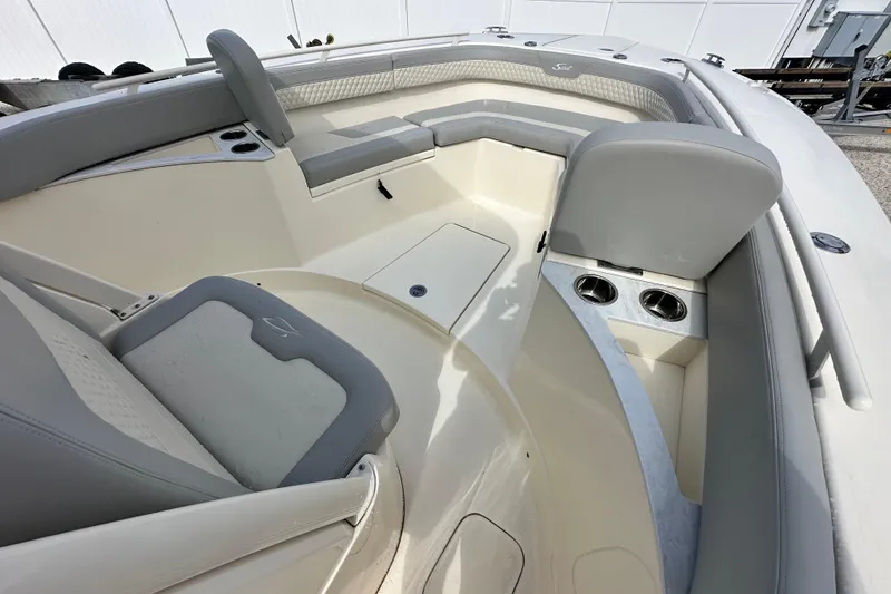 Slide: The Image of 2024 Scout 277 LXF boat interior with gray seating and cup holders. - 28