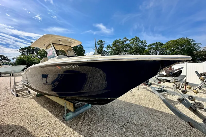 Slide: The Image of 2024 Scout 277 LXF boat on display under a clear blue sky. - 4