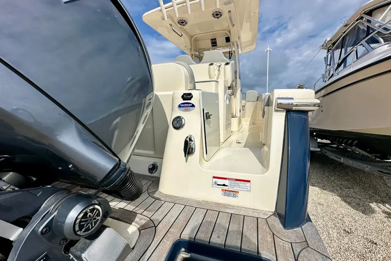 Slide: The Image of 2024 Scout 277 LXF boat with Yamaha engine, showcasing deck and seating area. - 6