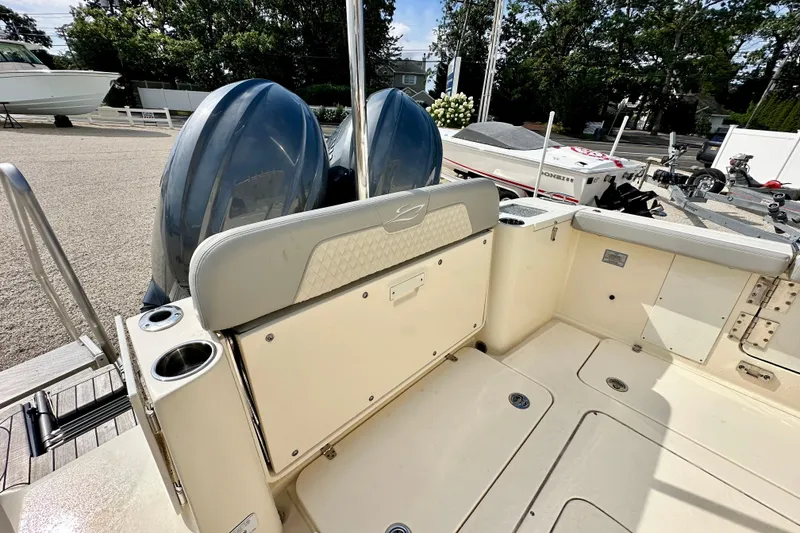 Slide: The Image of 2024 Scout 277 LXF boat interior with dual engines and seating area. - 7