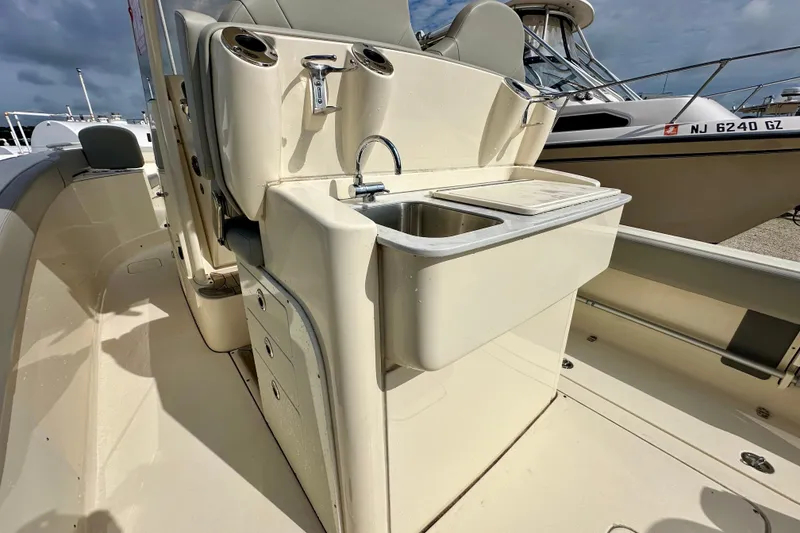 Slide: The Image of 2024 Scout 277 LXF boat interior with sink and storage compartments. - 9