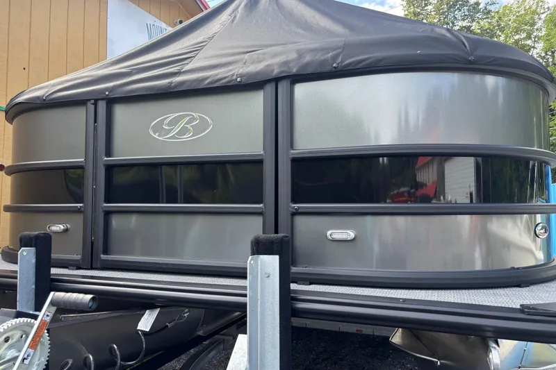 Slide: The Image of 2026 Bentley Pontoons Legacy 220 Swingback Dual Captain, sleek design, black and silver exterior. - 4