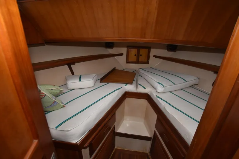 Slide: The Image of 1987 Hartman-Palmer Offshore 38 Sundeck cabin with striped cushions and wooden interior. - 14