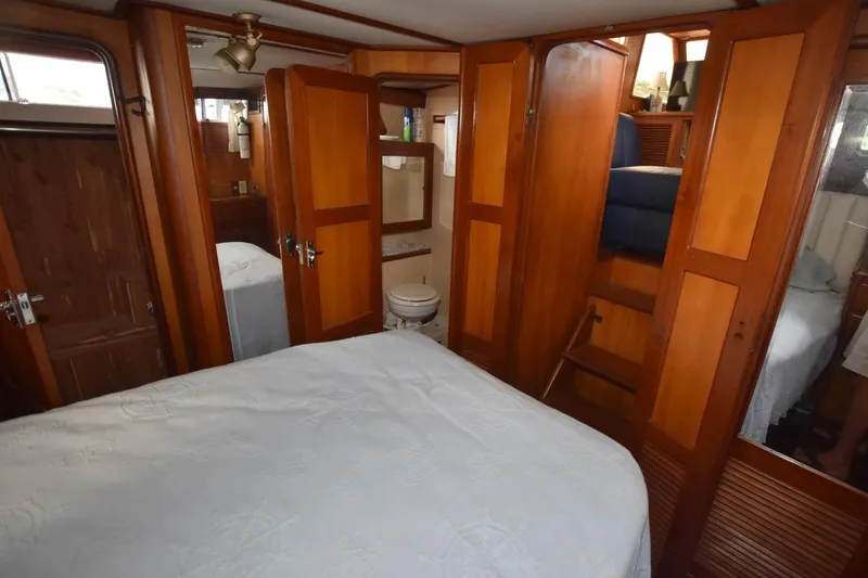 Slide: The Image of 1987 Hartman-Palmer Offshore 38 Sundeck interior with wood paneling and cozy bedroom. - 19