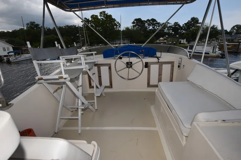 Slide: The Image of 1987 Hartman-Palmer Offshore 38 Sundeck with helm, seating, and director chairs on deck. - 21