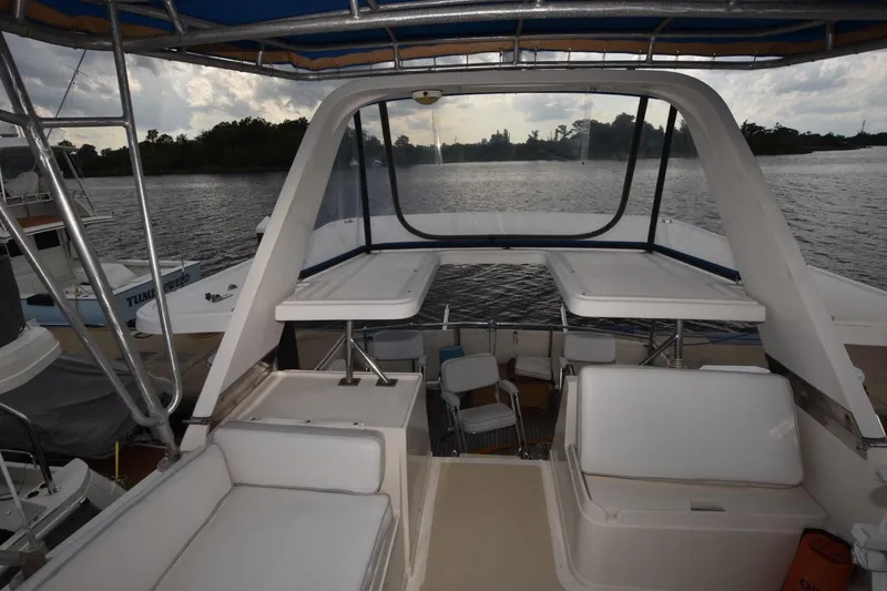 Slide: The Image of 1987 Hartman-Palmer Offshore 38 Sundeck, spacious deck with seating, overlooking serene waters. - 22